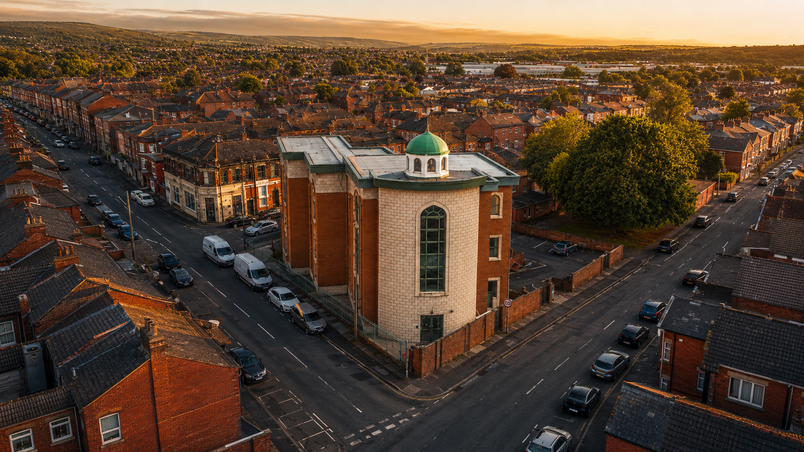 Aerial view of Makki Masjid and the surrounding Bolton neighbourhood at sunset